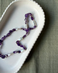 Amethyst nugget beads and long biwa pearls silk knotted and shown on a pale dish